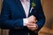 Hands of wedding groom in a white shirt dress cufflinks