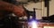 Hands of welder using welding torch
