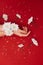 Hands with white flowers on red background