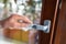 Hands wiping door handle with disinfectant wipe