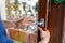Hands wiping door handle with disinfectant wipe