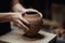 Hands of woman artist making elegant vase with creative pattern using mud