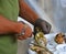 Hands of a woman with chain glove and knife opening an oyster