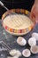 Hands of a woman cook stir in a glass bowl, pancake dough.