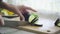 Hands of woman cutting eggplant on wooden board