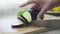 Hands of woman cutting eggplant on wooden board