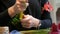 Hands of woman florist making a flower arrangement or a bouquet of fresh flowers