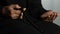 Hands of woman in hijab counting islamic beads and praying in mosque, religion