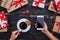 Hands of woman holding cup of coffee in one hand and telephone i