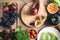 Hands of woman holding knife and cutting passion fruit on wooden board