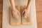 Hands of woman keeping her palms on metallic bristles of yoga massage pads