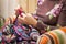 Hands of woman knitting a vintage wool quilt