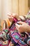 Hands of woman knitting a vintage wool quilt