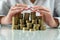 hands of a woman on a mirrored table with a roller coaster with coins hugging money.