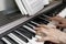 Hands of woman playing piano classical music, selective focus, close-up