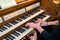 Hands of a woman playing the pipe organ