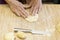 Hands of woman preparing dough pies to bake