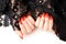 Hands of a woman with red manicure on background with black lace