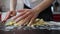 Hands of woman tries to unstick dough from the table