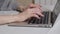 Hands of woman typing a message on a laptop, working during isolation period at home HD footage side view