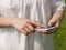 Hands of a woman using cellular phone