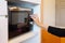 Hands woman using microwave oven in home kitchen