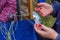 Hands of the woman weaving from threads a braid for production of traditional Circassian patterns and ornaments on clothes accesso