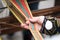 Hands of woman weaving traditional Lithuanian ethnic band from linen