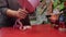 Hands of woman wrapping pink gift box