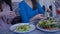 Hands of women friends using mobile phone for photo of beautiful salad during healthy dinner during diet for weight loss