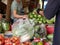 Hands of women negotiating / buying and selling fresh organic vegetables at a local market