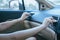 Hands of women turning on car air conditioning system,Button on dashboard in car panel