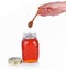 Hands wood spoon in  bottle honey,spoon on white background