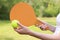 Hands with a wooden paddle for playing beach tennis close-up. Outdoor games