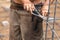 Hands of a Worker Securing Steel Rebar Framing With Wire Plier Cutter Tool