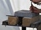 The hands of a worker Stonemason with chisel at work, stone slab on wooden blocks for processing