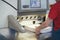 Hands of worker in typography working on cutter guillotine machine