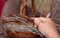 Hands working in a basket construction