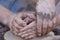 Hands working on pottery wheel