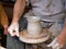 Hands working on pottery wheel