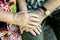 Hands with wrinkles of elderly couple, holding hands of seniors together close-up, concept of relationships, marriage