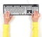 Hands in yellow jacket and grey keyboard