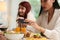 Hands of young Asian woman taking photo of tasty homemade meals