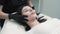 Hands of young beautician are doing relaxing face and neck massage