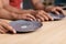 Hands of young black family hold plates with some grains of rice at table in kitchen, cropped