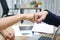 Hands of young business people giving fist bump together to greeting complete dealing in office. Success and teamwork concept