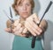 HANDS OF YOUNG CAUCASIAN WOMAN SHOWING THE OPEN SCISSORS AND BARBER BLADE IN CLOSEUP