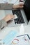 Hands of young contemporary businesswoman in formalwear wiping laptop keypad