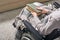 Hands of young disable woman in wheelchair holding book on her knees