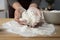 Hands of young female holding pile of sifted flour